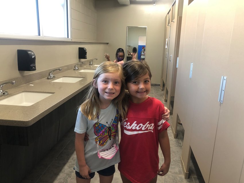 Azlee Hardy and Kynlee Bryan like the newly renovation restrooms in the second grade hall at Neshoba Central Elementary School.